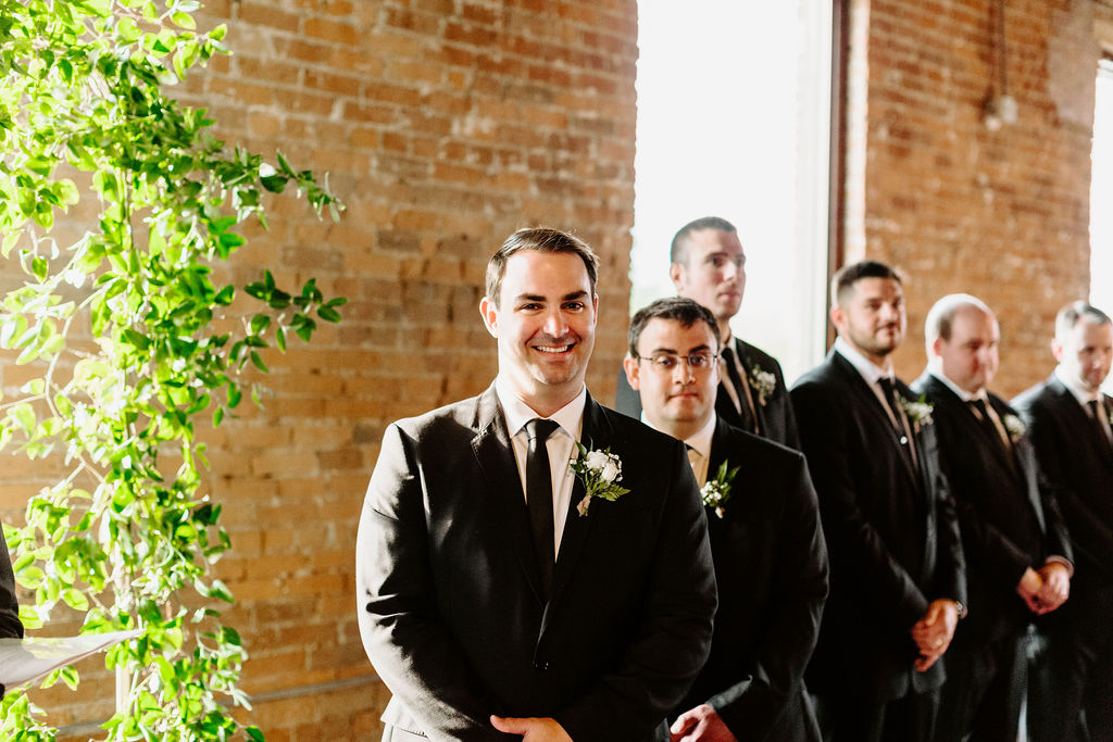 the groom and his groomsmen standing at the altar at the ceremony