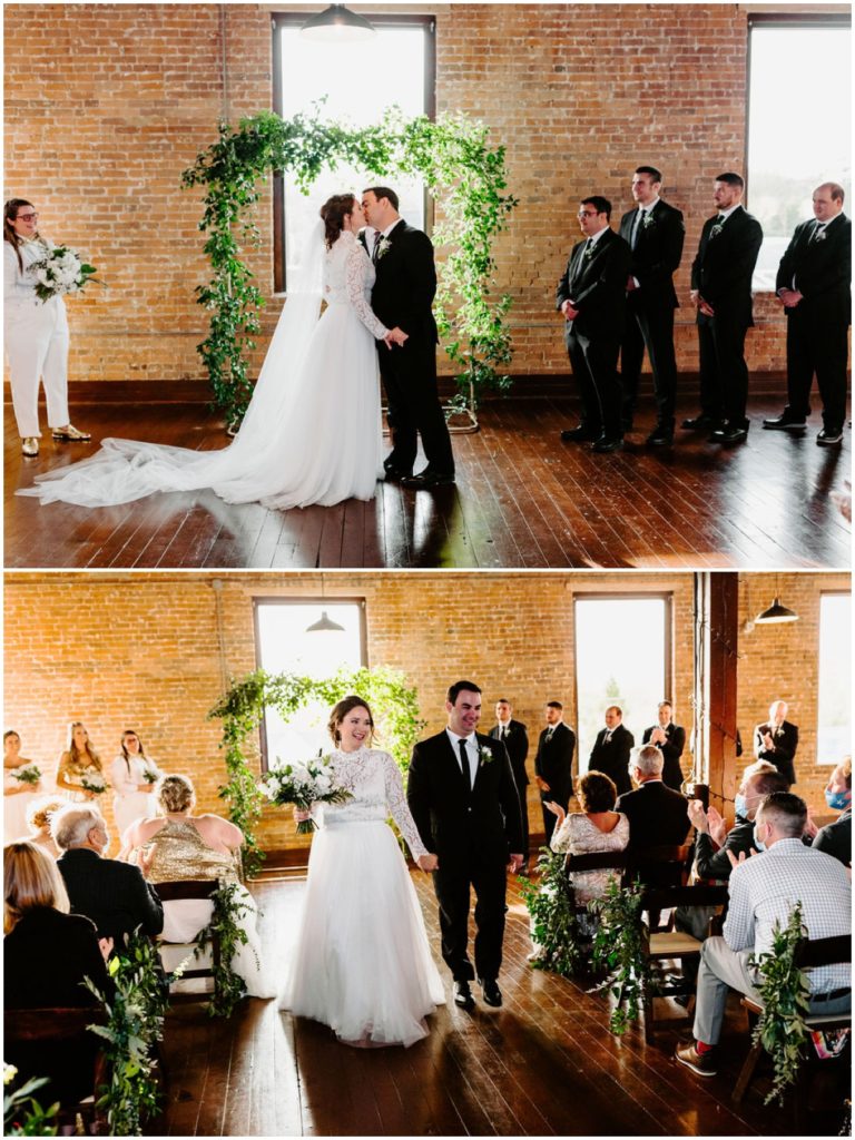 bride and groom kiss and walk down the aisle as husband and wife inside factory 12 event loft