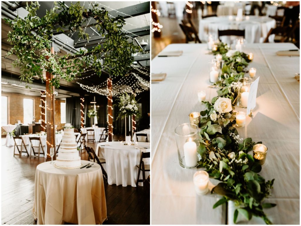industrial reception space with lights, candles, white linen and greenery hanging above and on the tables