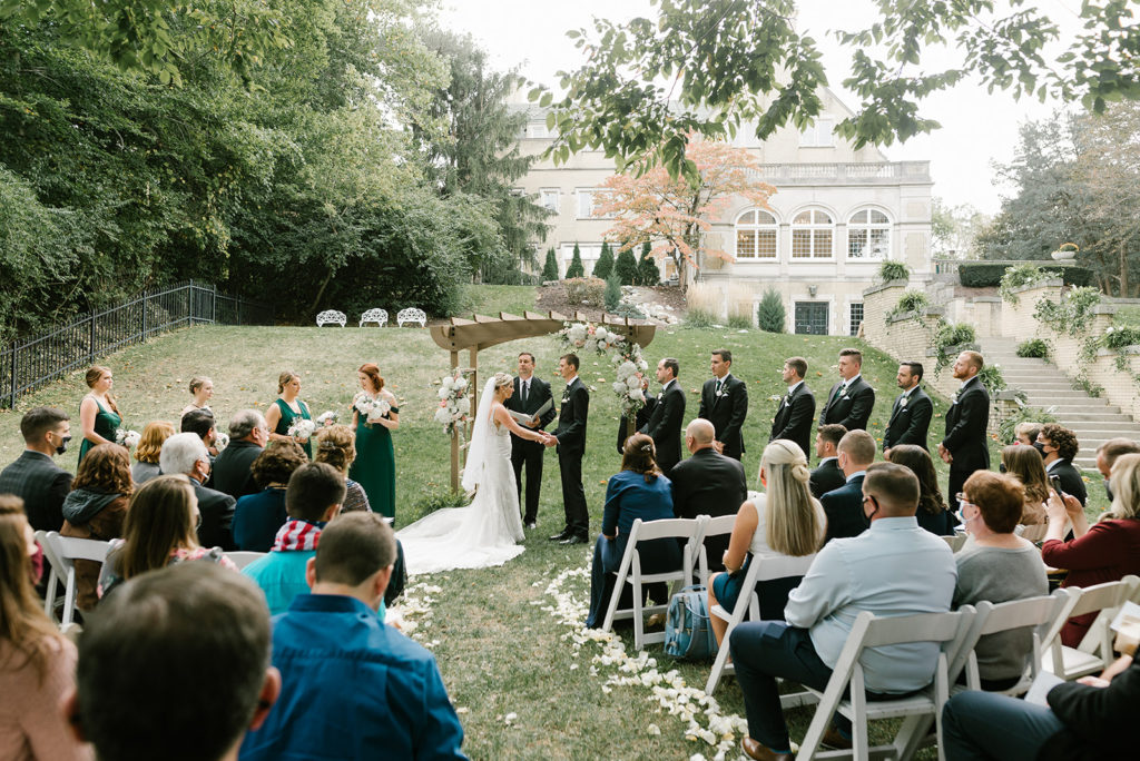 The ceremony with the bridal party and guests on the back lawn of Laurel Hall in Indianapolis Indiana