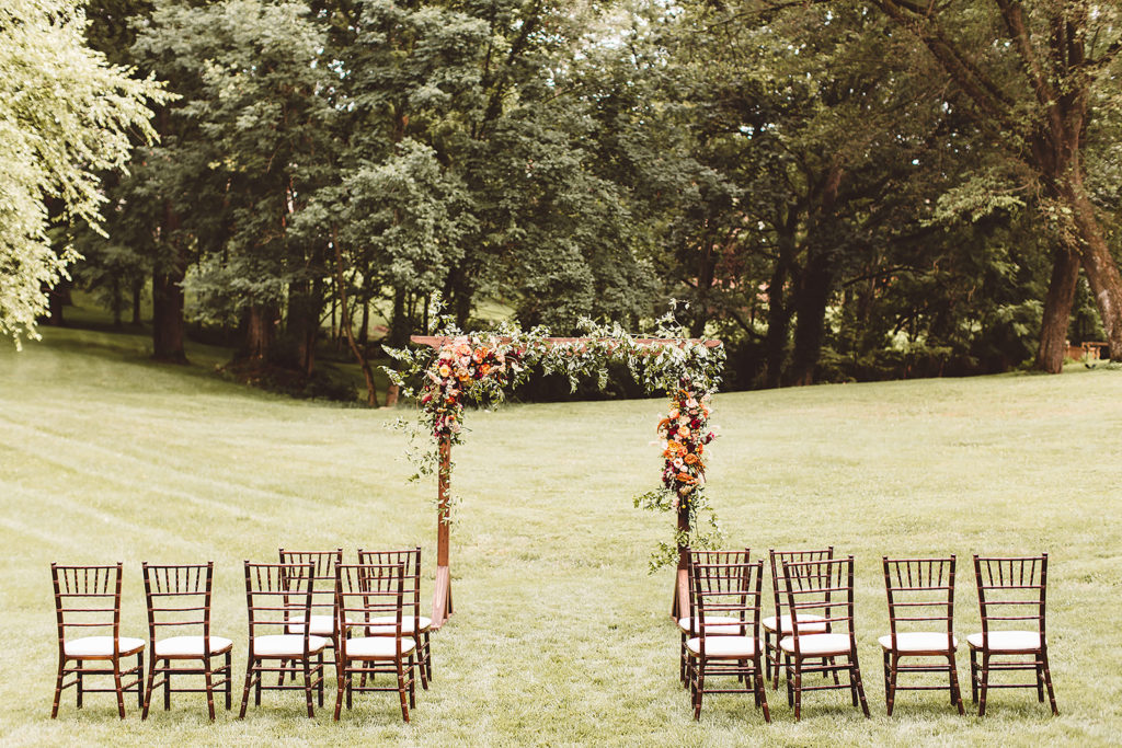 The intimate ceremony set up consisting of a floral arch and a handful of chairs in the backyard of this private property. 
