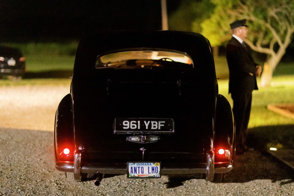 vintage black car waiting for the bride and groom outside of white willow farms