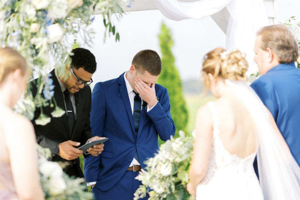 The groom is emotional as the bride and her father approach the altar 