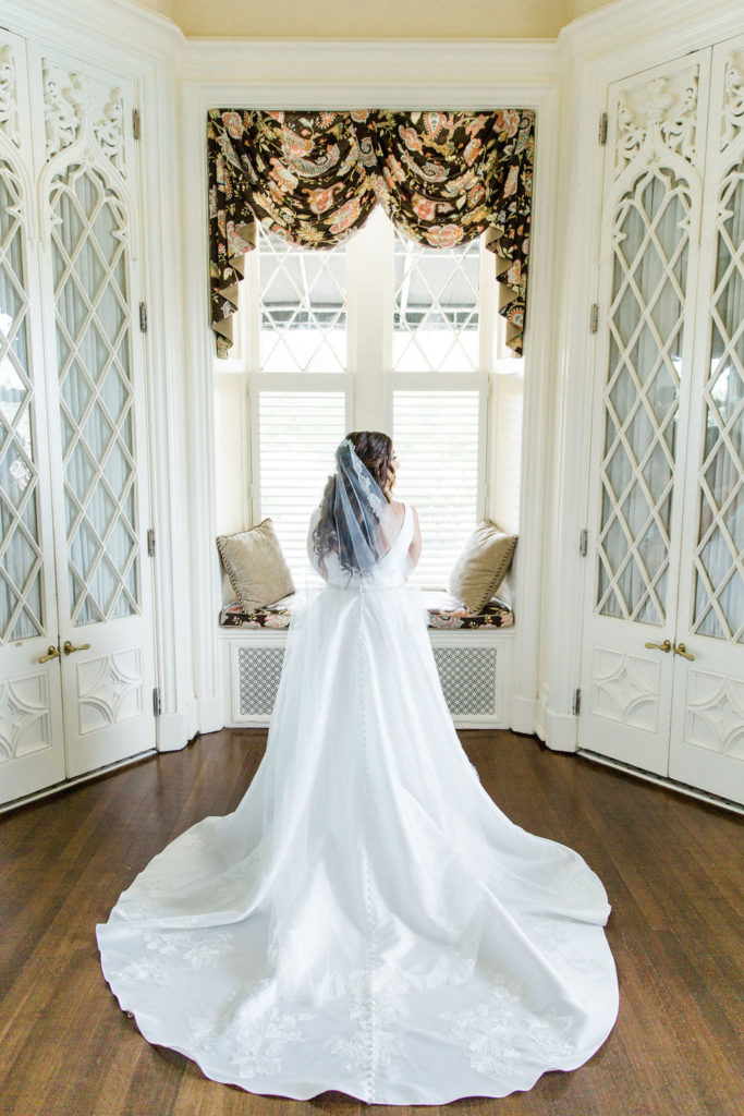 The back of the wedding dress highlighting the train and veil in the bridal room