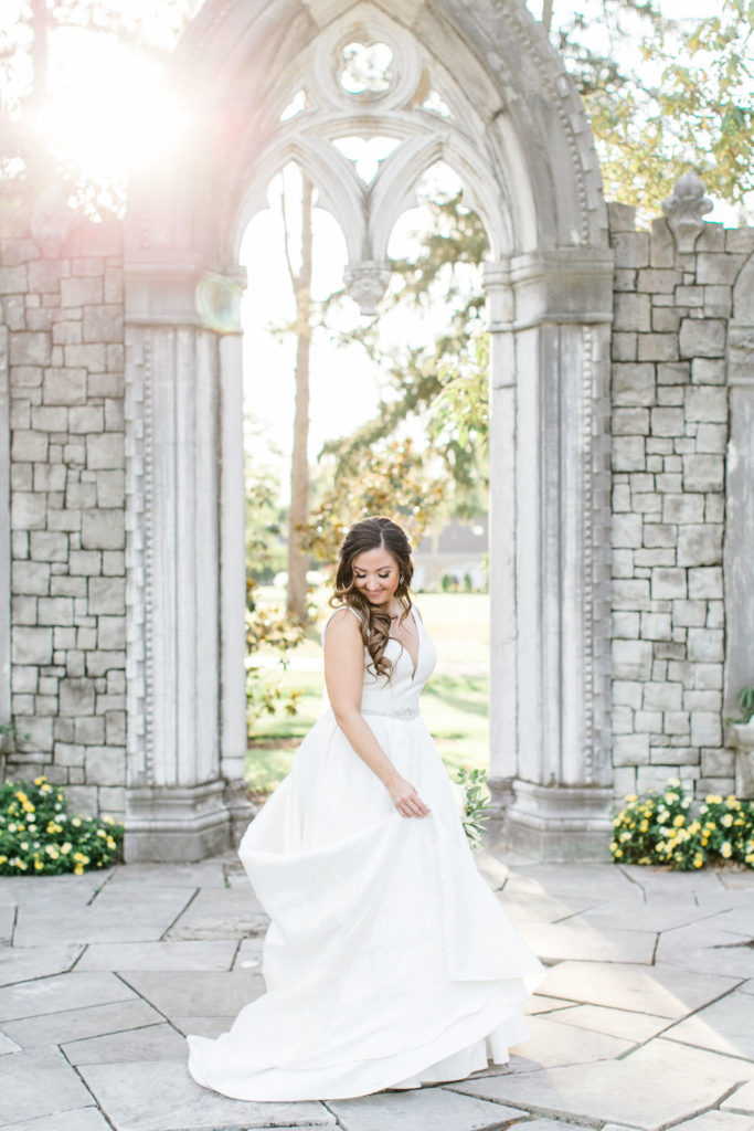 The bride twirling her dress at the Hurstbourne Country Club ceremony location