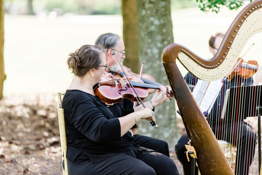 String quartet plays near the Hustbourne Country Club outdoor ceremony location 