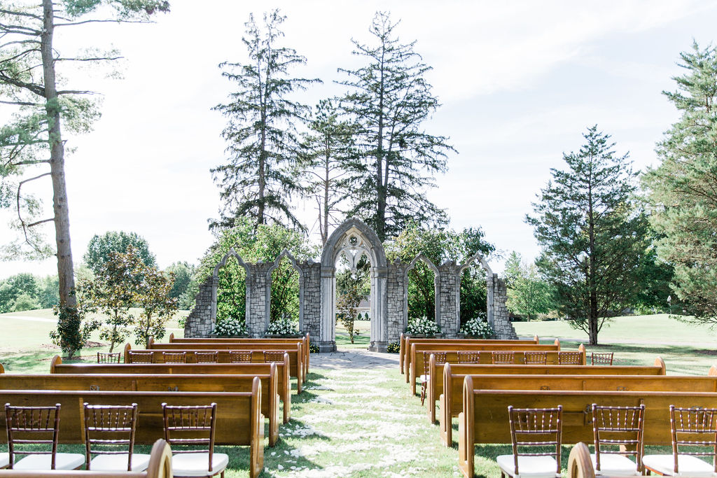 Church pews and chairs facing the outdoor stone chapel on the Hurstbourne Country Club grounds