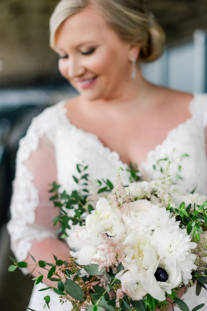 A close up shot of the bridal bouquet as the bride is holding it