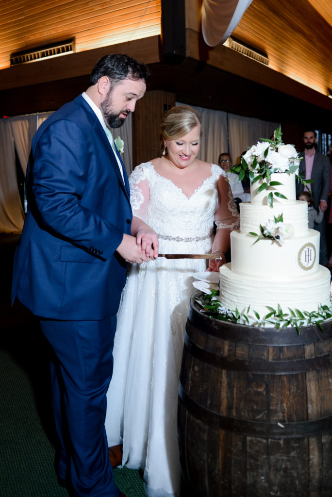 The bride and groom cutting into their wedding cake at Keeneland