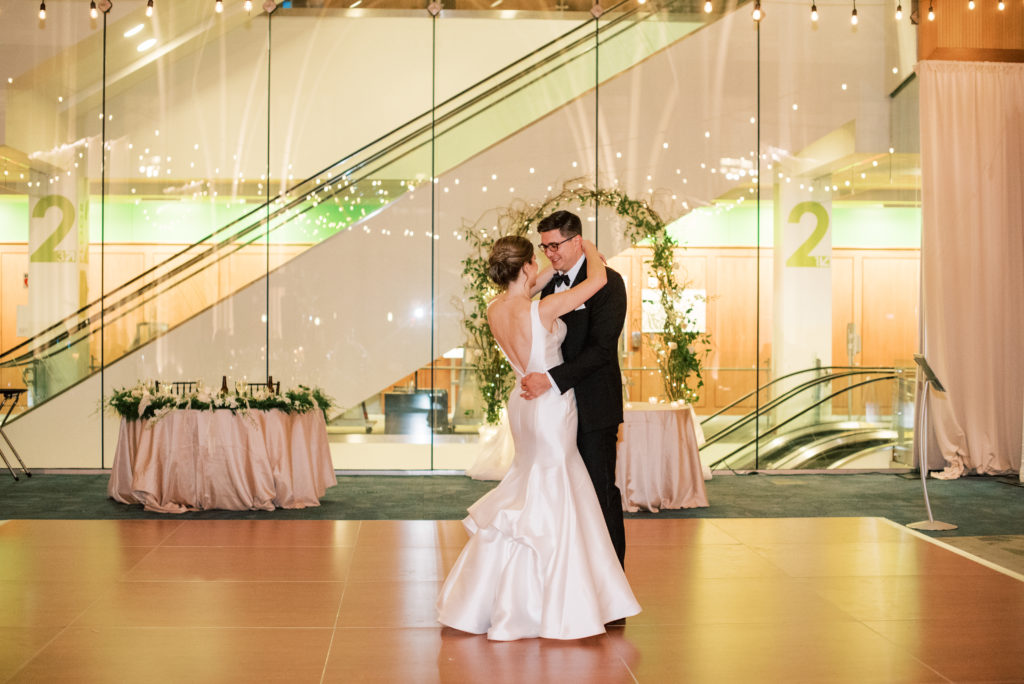 Bride and groom's first dance at their reception inside the Indianapolis central library