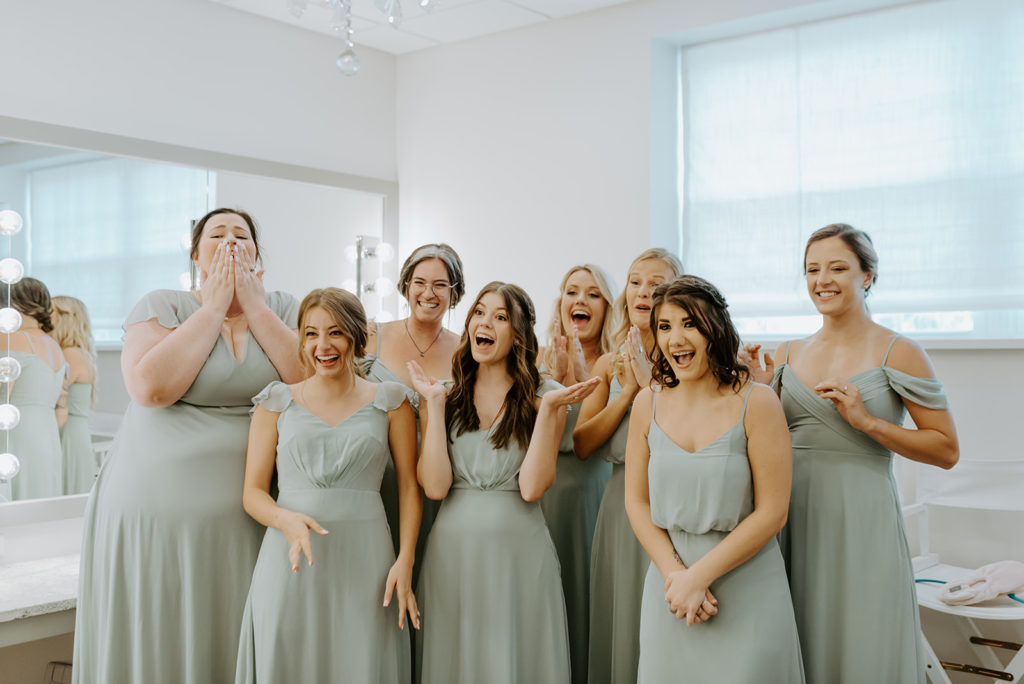 The bridesmaids are all shocked, exicited and thrilled as the bride steps out for their first look at daniel's vineyard