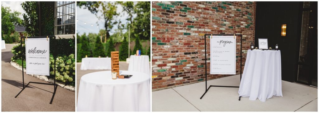 modern signs and tables lined with white linen with games were placed outside the Clerestory for cocktail hour