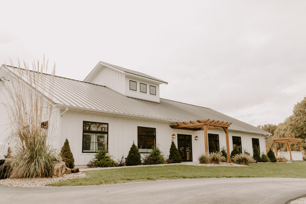 outside-photos-of-the-front-entrace-pergula-and-white-building-of-the-wild-wedding-venue