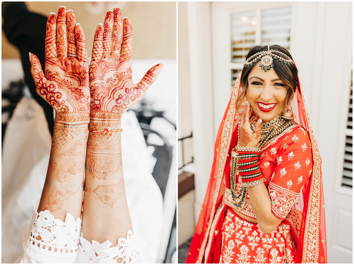 The brides hands together palms up showcase the detailed henna on her hands. And the bride dressed in her red traditional indiana wedding dress, head piece and jewlery, smiling.