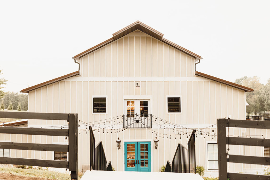Hazelnut farm venue entrance with blue double doors and sting lighting