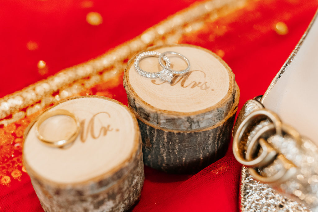 the bride and groom's wedding rings on small wooden stumps labeled "Mr" and Mrs."