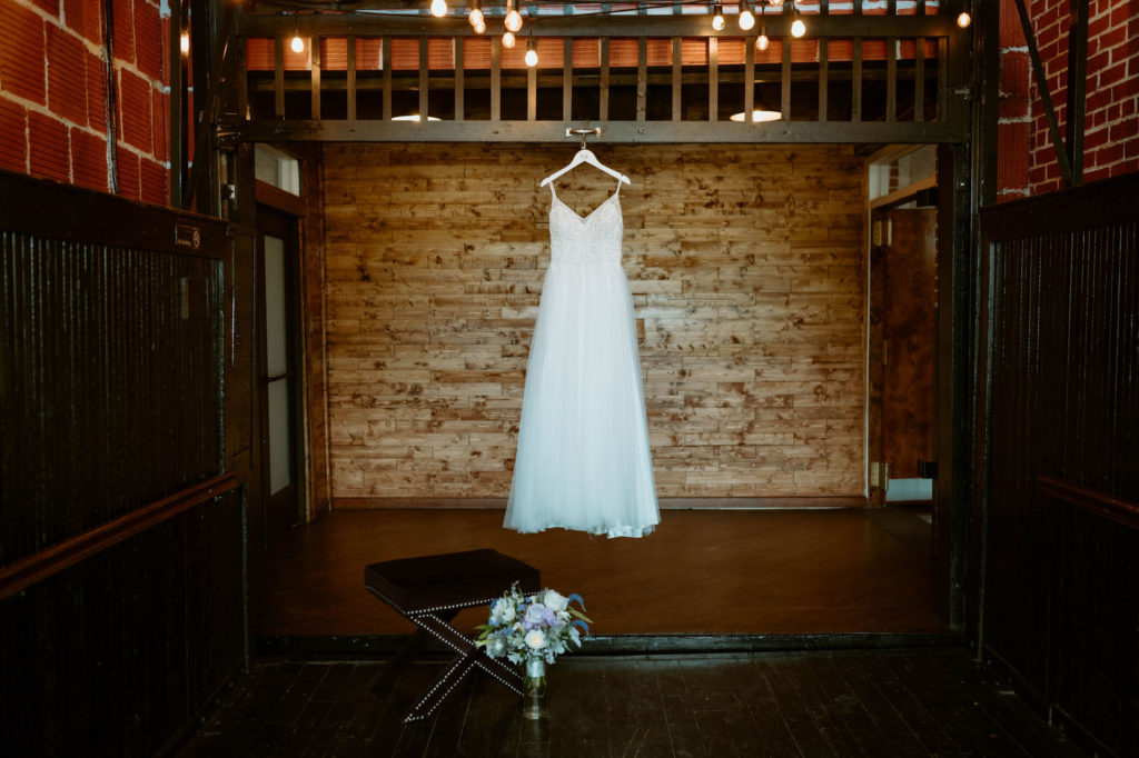Wedding dress hanging from the rafters in the industrial building