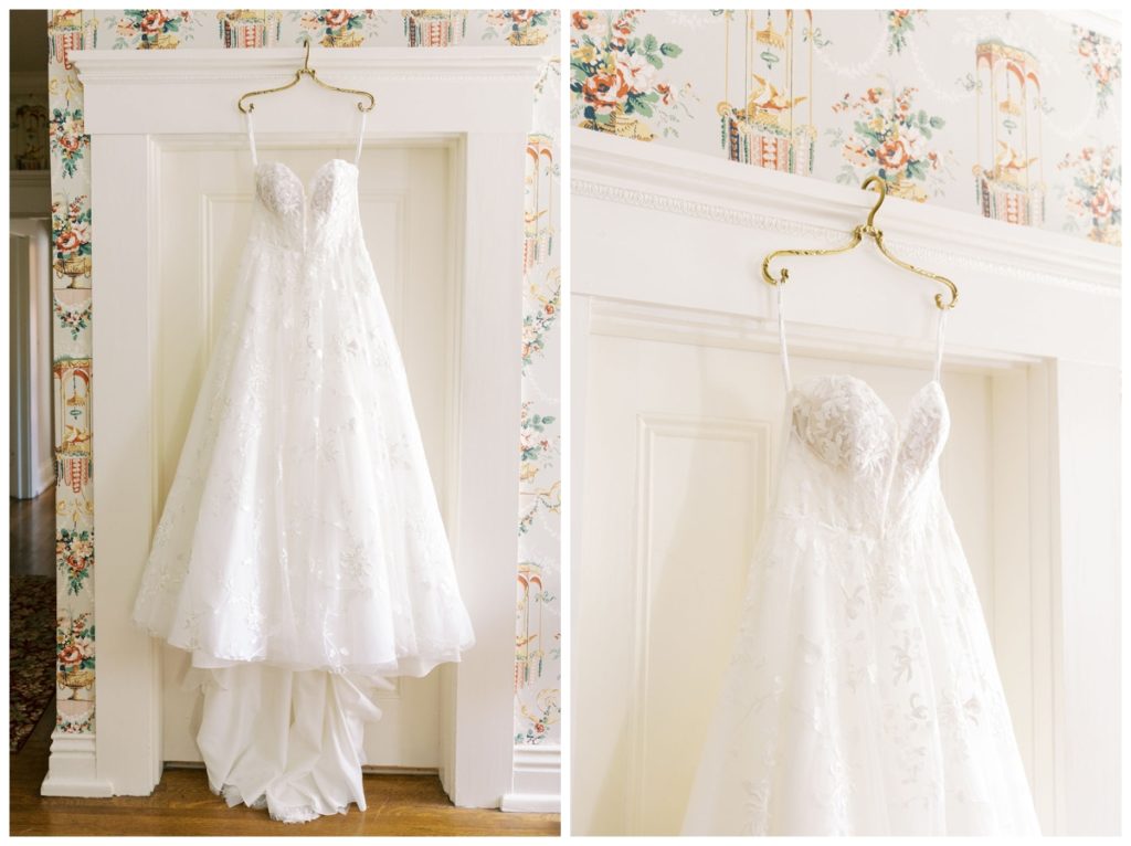 wedding-dress-hanging-on-a-gold-hanger-in-front-of-a-white-door-and-colorful-vintage-wallpaper-inside-whitehall-wedding-venue