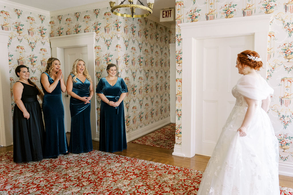 the-bride-showing-her-bridesmaids-her-dress-in-the-bridal-suite-at-whitehall-wedding-venue