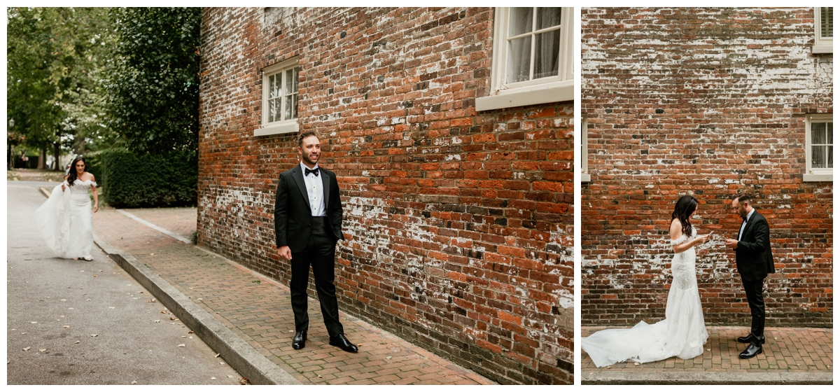 bride and groom first look in front of red brick wall
