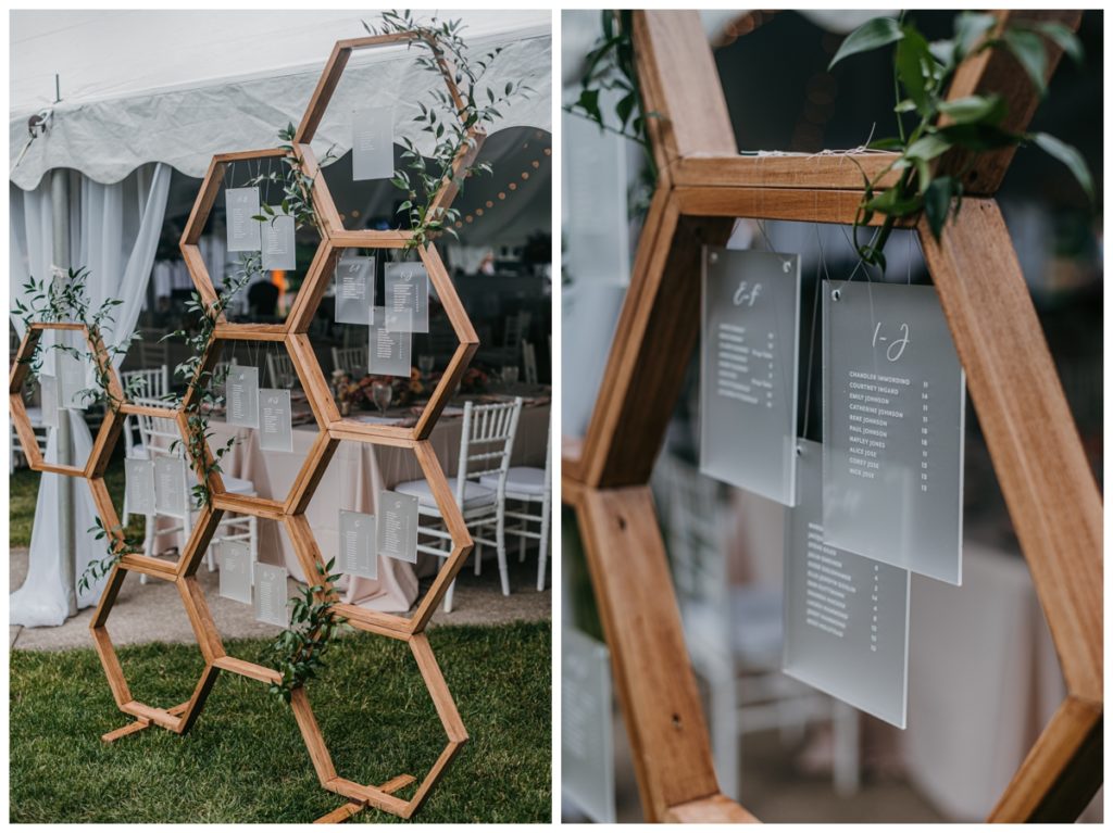 honeycomb inspired seating chart at the entrance of the wedding reception tent at this lake wedding