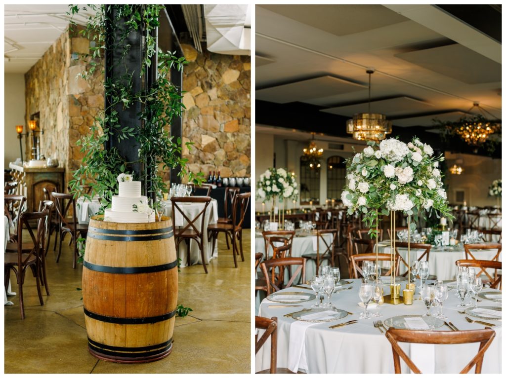 wedding cake on a wine barrel and a tall wedding reception floral centerpiece on a gold stand with white flowers and greenery