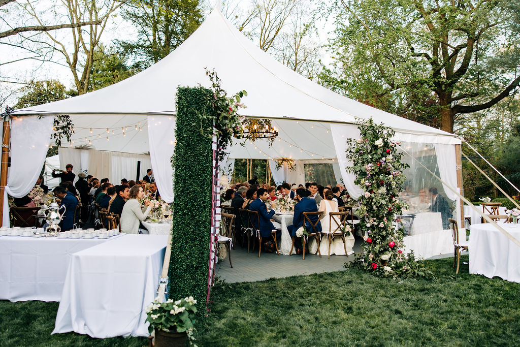 white backyard wedding reception tent all guests seating during dinner 