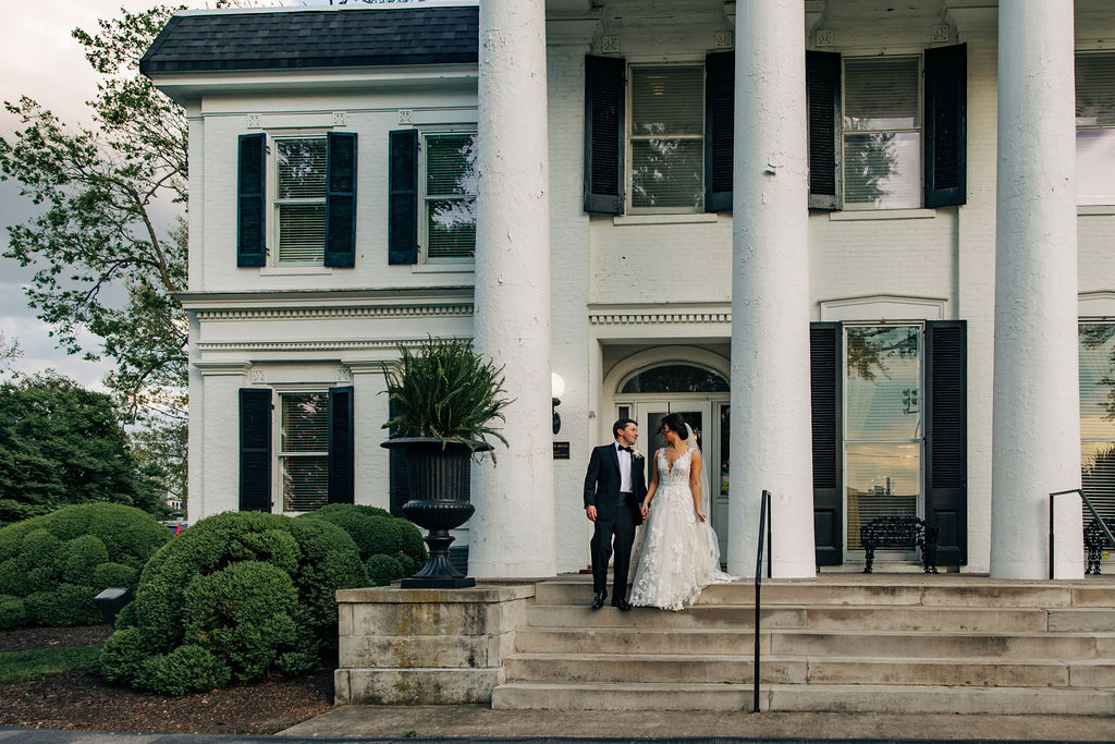 Carrick House Wedding with Bride and Groom on front steps 